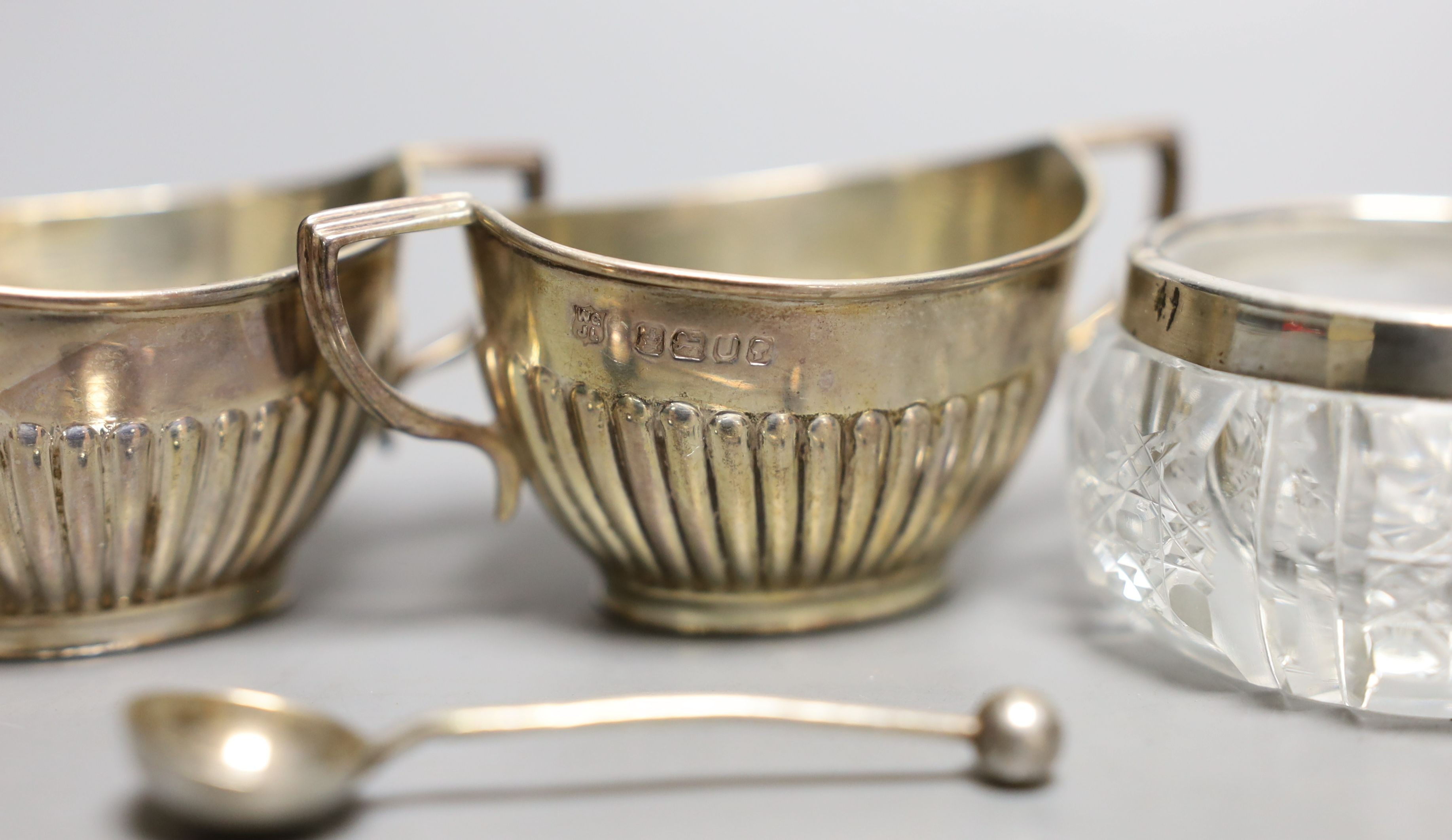 A set of four late Victorian demi-fluted silver salts and spoons, two other salts and a caster.